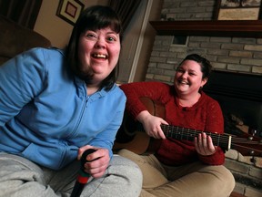 Angela Reaume, 30, left, has fun singing Shania Twain and Britney Spears songs with her music therapist, Candice Gardiner. (DAX MELMER / The Windsor Star)