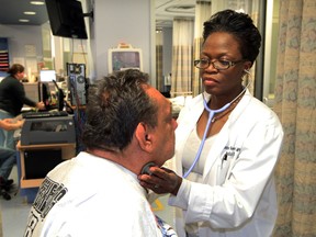 Dr. Monique Reeves of Detroit, Michigan, checks on emergency room patient Jose Castaneda at Windsor Regional Hospital's Ouellette Avenue campus Thursday April 10, 2014. (NICK BRANCACCIO/The Windsor Star)