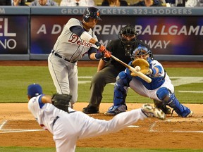 Detroit's Victor Martinez, top, hits an RBI sacrifice fly as Los Angeles pitcher Josh Beckett, bottom, throws to catcher Tim Federowicz in the first inning Wednesday in Los Angeles. (AP Photo/Mark J. Terrill)