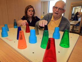 Patient Elmer Ames, 85, works on grasping skills with the help of occupational therapist Lisa Reshwen, left, at Hotel-Dieu Grace Healthcare, Tayfour Campus Friday April 11, 2014. Physiatrists are part of the rehab team. See story by Brian Cross. (NICK BRANCACCIO/The Windsor Star)