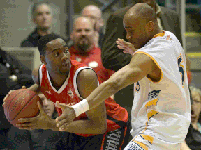 Windsor's Papa Oppong, left, is guarded by Antonio Ballard of the Island Storm Saturday in P.E.I. (The Guardian)