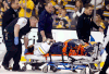 Buffalo’s Matt Hackett is carted off the ice on a stretcher after getting injured in the third period against the Boston Bruins in Boston Saturday. (AP Photo/Michael Dwyer)