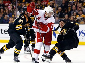 Detroit's Pavel Datsyuk, centre, is checked by Boston's Matt Bartkowski, left, and Gregory Campbell in Boston.