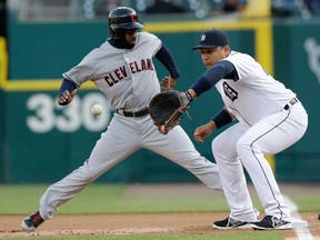 Cleveland's Michael Bourn, left, jumps back to first while Tigers first baseman Miguel Cabrera waits for the throw from starting pitcher Anibal Sanchez during the first inning in Detroit Wednesday. (AP Photo/Carlos Osorio)