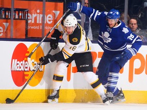 Boston's Reilly Smith, left, is checked by Toronto's Carl Gunnarsson at the Air Canada Centre. (Photo by Abelimages/Getty Images)