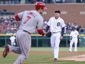 Detroit's Drew Smyly, right, reacts after giving up a walk to L.A.'s Colin Cowgill during the second inning Friday at Comerica Park. (Photo by Leon Halip/Getty Images)