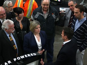Ontario NDP leader Andrea Horwath, centre, and MPP Percy Hatfield, left, receive a tour of Unconquered Sun from CEO, Sean Moore, right, before speaking with the media, Friday, April 4, 2014. (DAX MELMER/The Windsor Star)