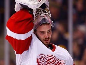 Detroit goalie Jonas Gustavsson takes his mask off against the Boston Bruins in Game 5 at TD Garden. (Photo by Jared Wickerham)