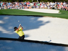 Bubba Watson of the United States hits a shot from a fairway bunker on the 18th hole during the first round of the 2014 Masters Tournament at Augusta National Golf Club on April 10, 2014 in Augusta, Georgia. (Photo by Harry How/Getty Images)