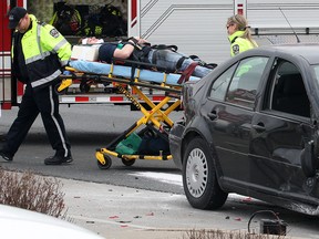 A motorist involved in a 3 car collision Monday, April 14, 2014, is transported by paramedics. The accident occurred at the intersection of Huron Church and Dorchester at approximately 4:00 p.m. (DAN JANISSE/The Windsor Star)