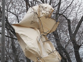 High winds caused a power outage Monday, April 14, 2014, to homes in the 2500 block of George Ave. after a large car canopy was blown into hydro wires. The canopy caused wires to short and burn. The canopy is shown in the wires. (DAN JANISSE/The Windsor Star)