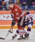 Ex-Spit Kerby Rychel, left, is checked by Saginaw's Dylan Sadowy. (TERRY WILSON/OHL Images)