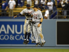 Detroit Tigers' Rajai Davis, left, Tyler Collins, center, and Austin Jackson, behind, celebrates after defeating the Los Angeles Dodgers 7-6 in a baseball game, Wednesday, April 9, 2014, in Los Angeles. (AP Photo/Mark J. Terrill)