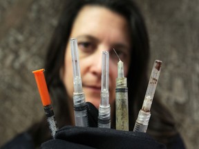 Anne-Marie Albidone, environmental services manager with the City of Windsor displays some of the discarded syringes found in city trash. There has been an increase in medical sharps in the garbage and workers being injured by them in the last two years. (DAN JANISSE/The Windsor Star)