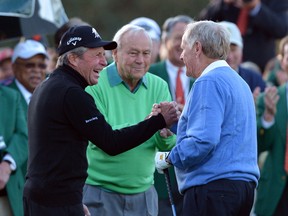 From left, Gary Player, Arnold Palmer and Jack Nicklaus shake hands after hitting ceremonial drives on the first tee during the first round of the Masters golf tournament Thursday, April 10, 2014, in Augusta, Ga. (AP Photo/Atlanta Journal-Constitution, Curtis compton)