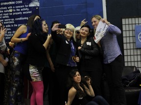 Meghan Agosta-Marciano is mobbed by fans during a stop at Cardinal Carter High School in Leamington on April 11, 2014. (Sean Previl/Special to The Star)