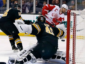 Detroit’s Henrik Zetterberg, right, scores a goal on Boston goalie Tuukka Rask with Reilly Smith back on the play in Boston. (ELISE AMENDOLA/AP photo)