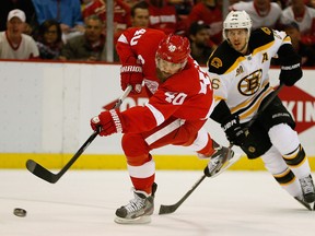 Detroit's Henrik Zetterberg, left, takes a shot in front of David Krejci Thursday in Game 4. (Photo by Gregory Shamus/Getty Images)