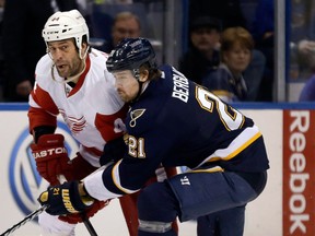 Detroit's Todd Bertuzzi, left, is checked by Patrik Berglund of the Blues in St. Louis. (AP Photo/Jeff Roberson)