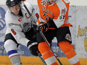 Essex 73's Philip Janikowski, right, protects the puck from Dorchester's Brady Verougstraete at the Essex Centre Sports Complex in Essex. (TYLER BROWNBRIDGE/The Windsor Star)