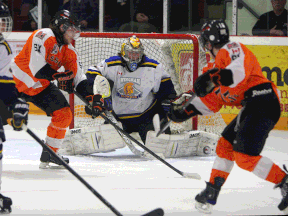 The Essex 73's Jordan Ryan, left, and Tyler Scott try to deflect the puck past Wingham's Ben Nelson at the Essex Centre Sports Complex in Essex. (TYLER BROWNBRIDGE/The Windsor Star)