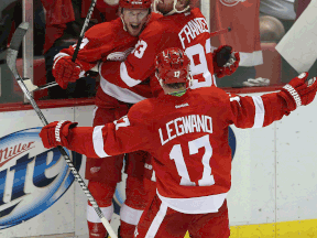 Detroit's Gustav Nyquist, left, is congratulated by his teammates Johan Franzen, right and David Legwand after Nyquist scored the winner against the Boston Bruins at Joe Louis Arena Wednesday. (Photo by Leon Halip/Getty Images)