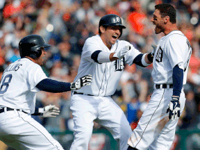Detroit's Ian Kinsler, right, celebrates after hitting a walkoff single with teammates Tyler Collins, left, and Nick Castellanos against the Kansas City Royals in the 10th inning at Comerica Park Wednesday. (AP Photo/Paul Sancya)