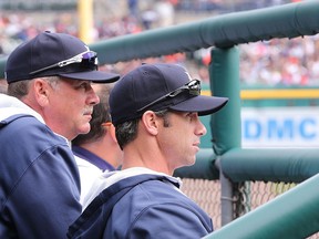 Detroit Tigers pitching coach Jeff Jones #51 and manager Brad Ausmus #7 watch the action from the dugout during the game against the Baltimore Orioles at Comerica Park on April 6, 2014 in Detroit, Michigan. The Orioles defeated the Tigers 3-1. (Photo by Leon Halip/Getty Images)
