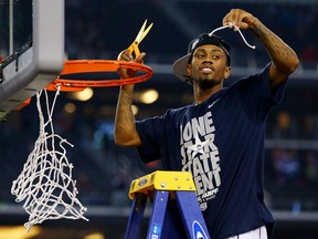 Ryan Boatright of the Connecticut Huskies cuts the net after defeating the Kentucky Wildcats 60-54 in the NCAA Men's Final Four Championship at AT&T Stadium Monday in Arlington, Texas. (Photo by Ronald Martinez/Getty Images)