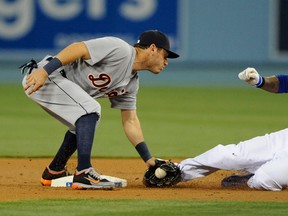 Detroit's Ian Kinsler, left, tags out Carl Crawford of the Dodgers as he attempts to steal second base during the first inning Tuesday in Los Angeles. (AP Photo/Kelvin Kuo)