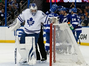 Toronto goalie James Reimer, left, retrieves the puck from the net as members of the Tampa Bay Lightning celebrate a goal at the Tampa Bay Times Forum Tuesday. (Photo by Mike Carlson/Getty Images)