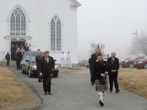 Piper Kenneth MacKenzie leads the funeral procession for the late Alistair MacLeod at St. Margaret of Scotland Church in Broad Cove, N.S., on Saturday, April 26, 2014. A funeral mass for writer Alistair MacLeod on Saturday resembled one of his meticulously crafted stories, blending well-chosen words, Celtic lament and insights into a life.About 300 people filled the 167-year-old St. Margaret of Scotland Roman Catholic Church in Broad Cove, N.S., near his summer home in Dunvegan, for the ceremony and burial in the neighbouring graveyard. (Vaughan Merchant/The Canadian Press)