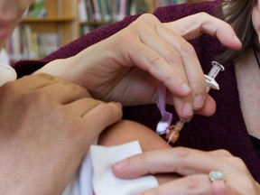 A student gets a measles shot at a school in 2012. (Postmedia News files)