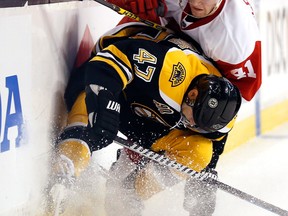 Boston Bruins defenseman Torey Krug (47) stops Detroit Red Wings' Luke Glendening (41) from getting around him during the first period of Game 2 of a first-round NHL hockey playoff series in Boston, Sunday, April 20, 2014. (AP/Winslow Townson) ORG