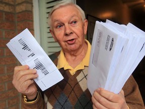 Michael Somerville was shocked to find 78 identical EnWin bills jammed into his mail box in Southwood Lakes Friday April 25, 2014.  (NICK BRANCACCIO/The Windsor Star)