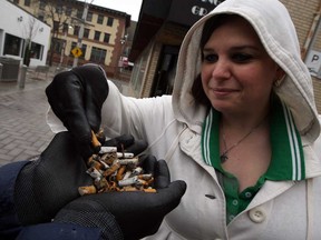 Ugly cigarette butts were picked off Maiden Lane by Rose City Clean Sweep volunteers Jean Di Giacomo, right, and Malcolm Brown, left,  Friday April 25, 2014.  (NICK BRANCACCIO/The Windsor Star)