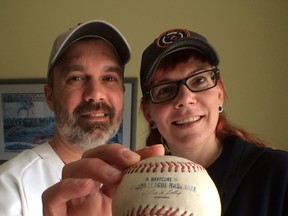 Rob Lucier and Ali McCabe display a Major League Baseball official ball given to McCabe after she caught Miguel Cabrera's 2,000th hit recently at Comerica Park.  McGabe gave the actual ball to Comerica Park officials and in return they gave her an autographed ball.  (JASON KRYK/The Windsor Star)