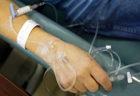 Files: A cancer patient holds the tubes that are treating him with chemotherapy. (Getty Images files)