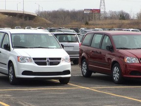 Chrysler and Dodge minivans are lined up at a holding yard at Central and Grand Marais Road east in Windsor, Ontario on April 21, 2014.  (JASON KRYK/The Windsor Star)