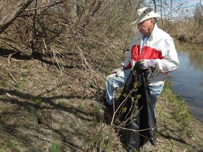 Past president of Windsor Rotary 1918, Ron Arkell, picks up litter along the riverbed of Little River during the 3rd annual Earth Day Environmental Cleanup, Saturday, April 26, 2014.  The event was put on by Windsor Rotary 1918 and Rotaract University of Windsor.  (DAX MELMER/The Windsor Star)