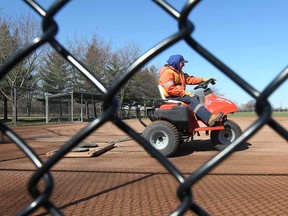 Windsor parks and rec employee Phil Rogers grooms a baseball diamond in this file 2011 file photo. City fields will be closed until May 5. (DAN JANISSE/The Windsor Star)