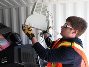 Nick Anstett, 17, a volunteer with Computers for Kids, helps unload computer products dropped off at the E-Waste Recycling Day hosted by Devonshire Mall, Saturday, April 12, 2014.  (DAX MELMER/The Windsor Star)