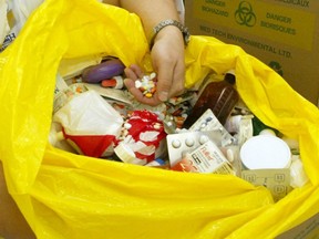 A Windsor pharmacist disposes of expired, unused medication in this 2002 file photo. (Kristine Racicot / The Windsor Star)