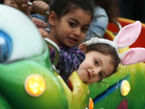 Maya Ayoub, 4, from Windsor, wears her bunny ears on the Caterpillar ride at Colasanti's Easter Egg-stravaganza, Friday, April 18, 2014.  (DAX MELMER/The Windsor Star)