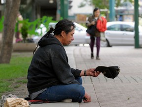 A panhandler in 2008 in Edmonton -- which has bylaws against aggressive panhandling. (Larry Wong / Edmonton Journal)