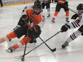 Colin Delaet, front, of the Essex 73's is tripped up during Game 4 of the Schmalz Cup final against the Lakefield Chiefs at Essex Arena on Sunday, April 27, 2014. (DAX MELMER/The Windsor Star)