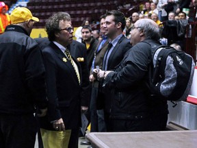 London Free Press reporter Morris Dalla Costa (right) talks with people from the London Lightning after he was asked to leave by the Windsor Express at the WFCU Centre in Windsor on Tuesday, April 1, 2014.                         (TYLER BROWNBRIDGE/The Windsor Star)
