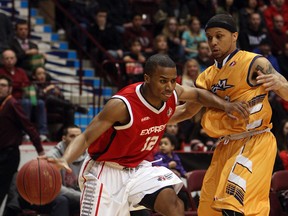 The Windsor Express' Darren Duncan cuts around the Island Storm's Adrian Moss at the WFCU Centre in Windsor on Tuesday, April 15, 2014. (TYLER BROWNBRIDGE/The Windsor Star)