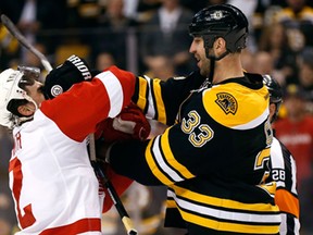 Boston Bruins' Zdeno Chara (33) mixes it up with Detroit Red Wings' Brendan Smith during the first period of Game 2 of a first-round NHL hockey playoff series in Boston, Sunday, April 20, 2014. (AP/Winslow Townson)