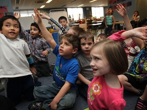 Gavin Pham, left, Edoardo Viselli, 5, and Daria Gillis, 5 join other junior and senior kindergarten students as they learn french with Rosemary Auger at St. Anne French Immersion Catholic School, Thursday, April 3, 2014.  (DAX MELMER/The Windsor Star)